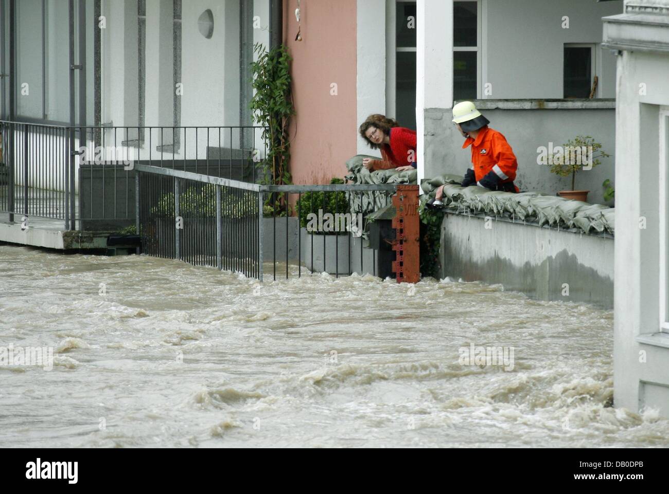 A resident and a fireman look anxiously at the rising water level of the High Rhine in Rheinfelden, Switzerland, 09 August 2007. Last night's heavy rains caused the High Rhine to flood. Officials in Baden-Wuertemberg are afraid that the Rhine River may burst its banks today. Photo: Rolf Haid Stock Photo