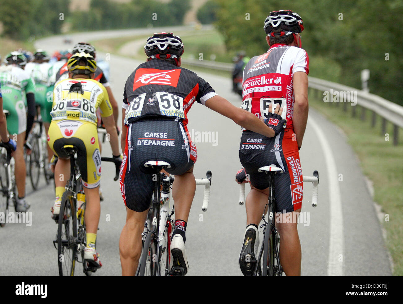 Spanish cyclist Luis Leon Gil Sanchez (C) pushes fellow-countryman and teammate Jopse Rojas Gil (R) of Team Caisse d'Epargne for him to rest during the seventh stage of the 'Germany Tour' in Regensburg, Germany, 16 August 2007. The seventh stage covers the 192.2 kilometres distance between Ausrian Kufstein and Regensburg. The Germany Tour leads in nine stages over 1,292.5 kilometre Stock Photo