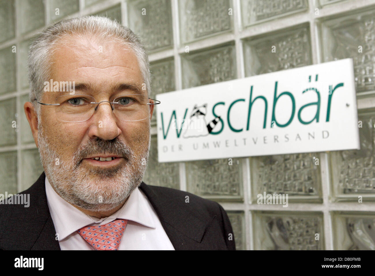The owner and managing director of eco mailorder service company  'Waschbaer', Ernst Schuetz, smiles into the camera in front of the company  logo in Freiburg, Germany, 21 August 2007. Schuetz is responsible