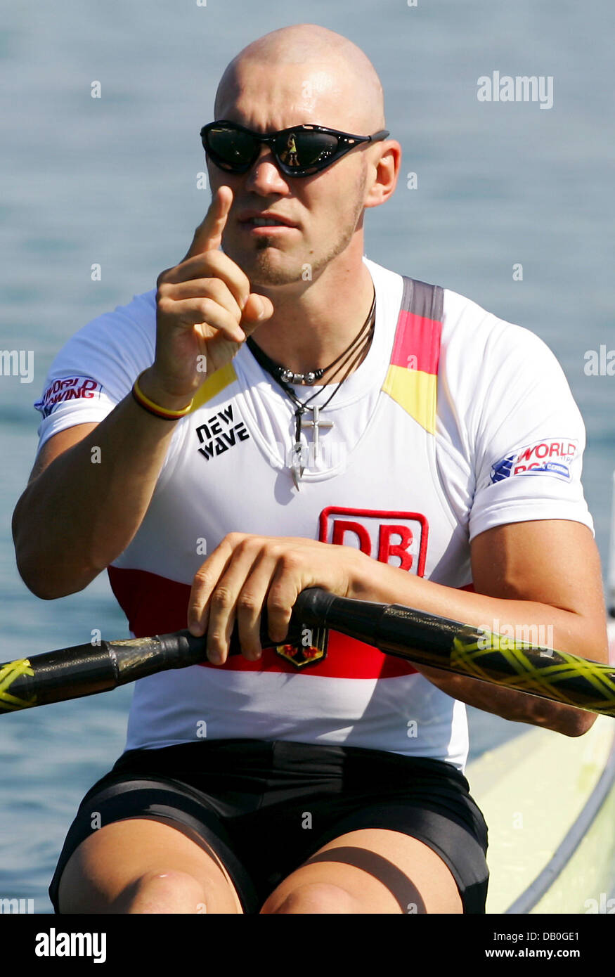 German rowing athlete Marcel Hacker gestures in his boat ahead of the ...