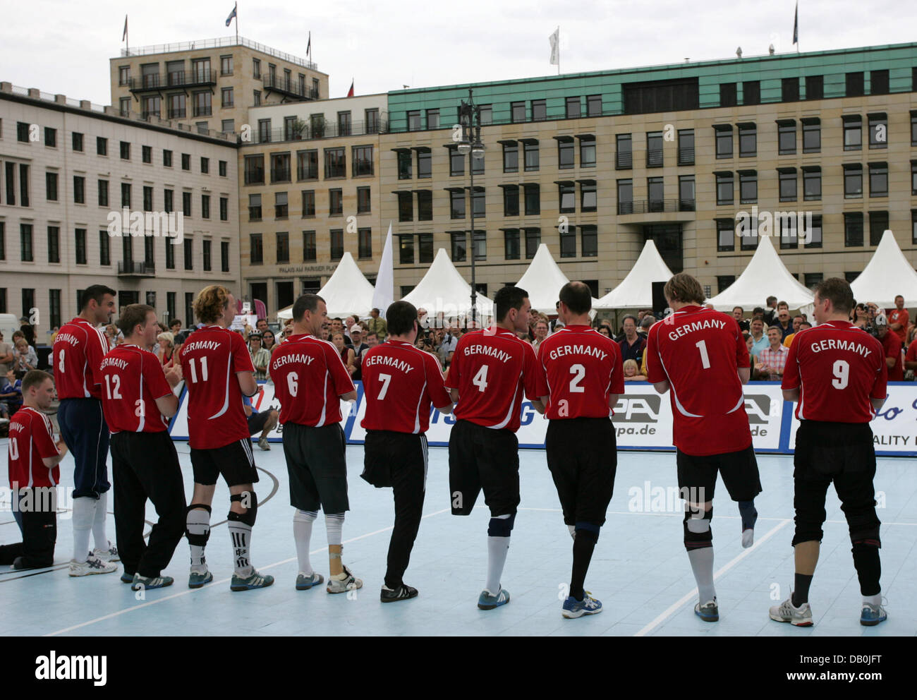 (dpa file) - The German national team is pictured prior to their sitting volleyball match against the national team of Bosnia-Herzegovina during the Paralympic Day at the Brandenburg Gate in Berlin, 23 August 2007. A year prior to the Paralympic Games in Beijing the 3rd Paralympic Day takes place in Berlin. Photo: Rainer Jensen Stock Photo