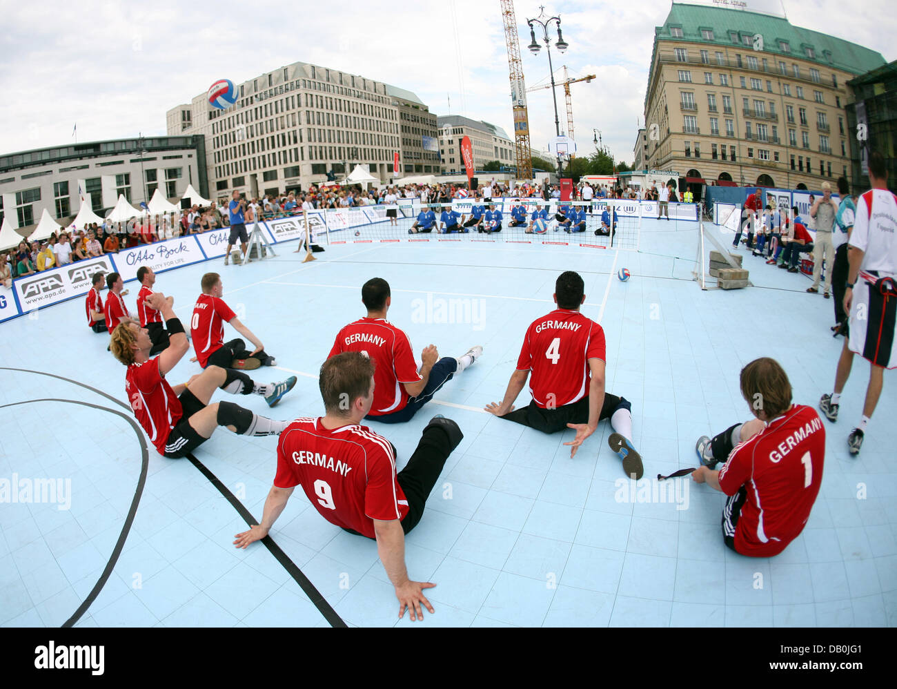 (dpa file) - The German national team and their opponents from Bosnia-Herzegovina prepare for their sitting volleyball match during the Paralympic Day at the Brandenburg Gate in Berlin, 23 August 2007. A year prior to the Paralympic Games in Beijing the 3rd Paralympic Day takes place in Berlin. Photo: Rainer Jensen Stock Photo