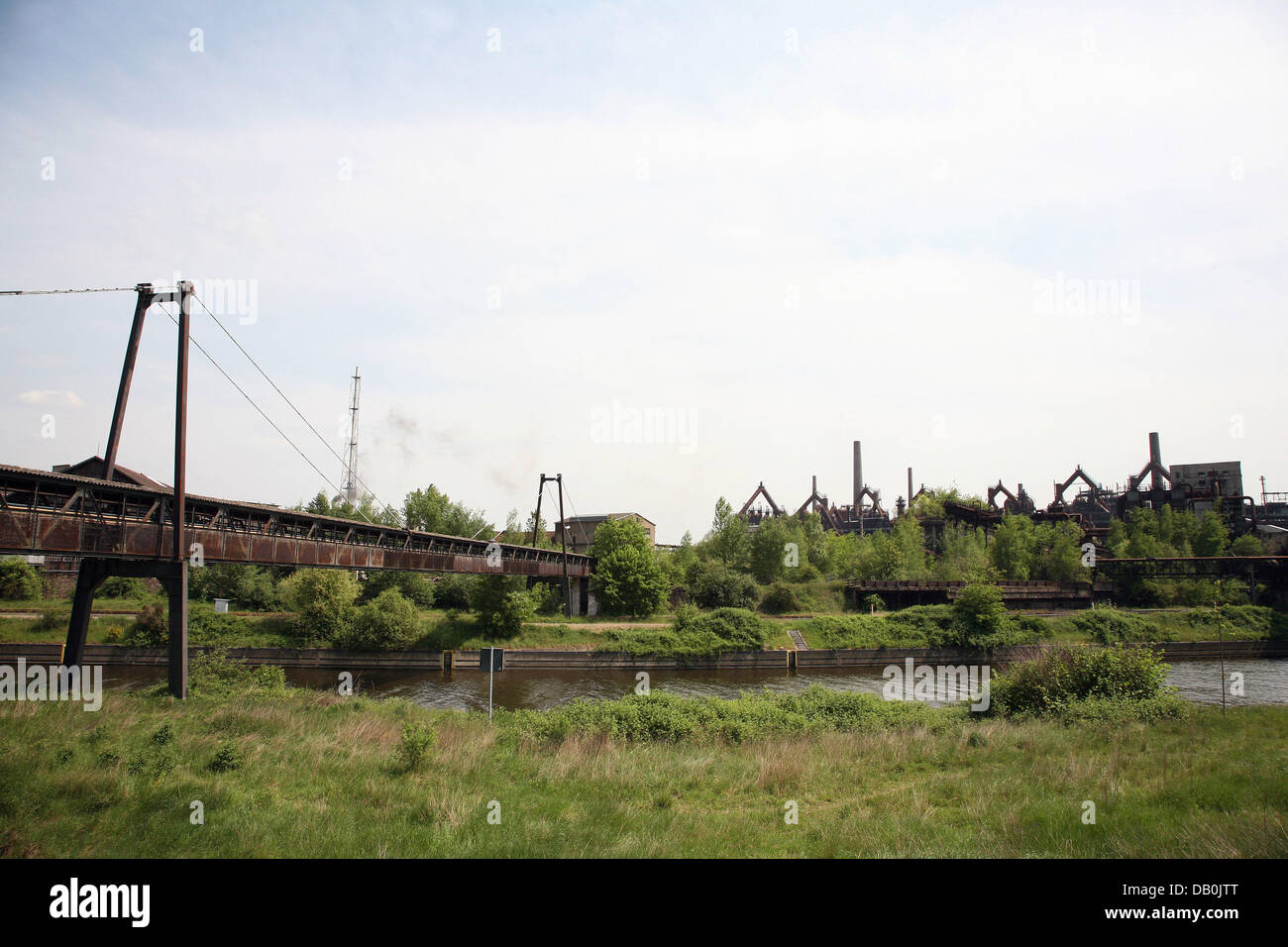 The photo shows rust covered furnaces and chimneys behind green bushes on the factory compounds of former steelworks 'Voelklinger Huette' in Volekingen, Germany, 5 May 2007. In 1994 the steelworks were the first industrial monument in the world to be declared a World Heritage by the UNESCO. Photo: Heiko Wolfraum Stock Photo