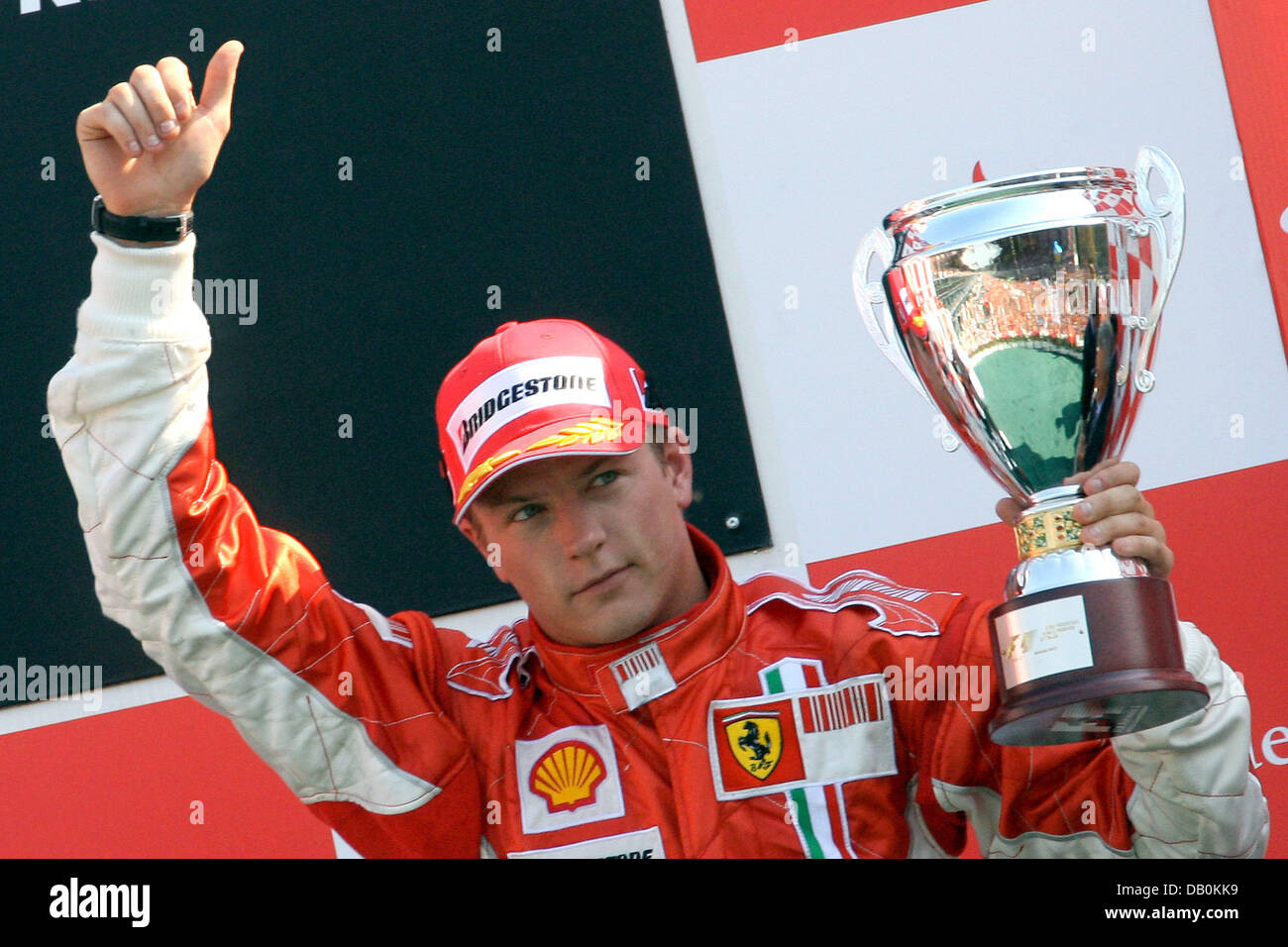 Third-placed Finnish Formula One pilot Kimi Raikkonen of Ferrari celebrates with his trophy as he stands on the podium after the Italian Grand Prix at the circuit in Monza, Italy, 09 September 2007. Photo: Jens Buettner Stock Photo