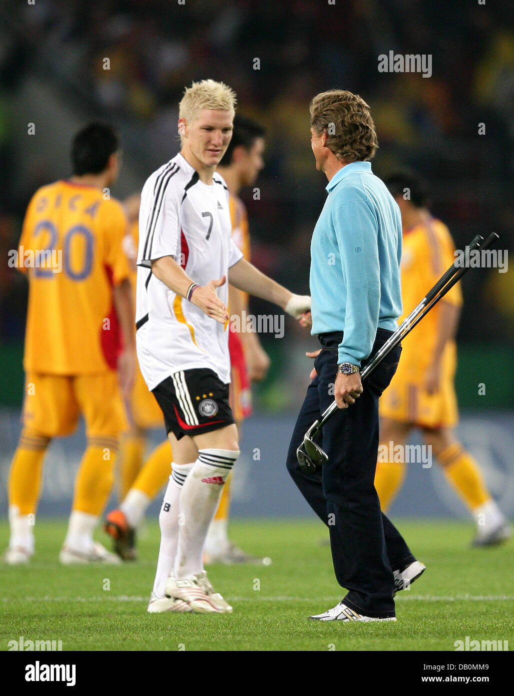 German midfielder Bastian Schweinsteiger (L) and German Golf professional  Bernhard Langer greet each other during half time on the pitch during the  soccer friendly Germany vs Romania at RheinEnergie-Stadion in Cologne,  Germany,