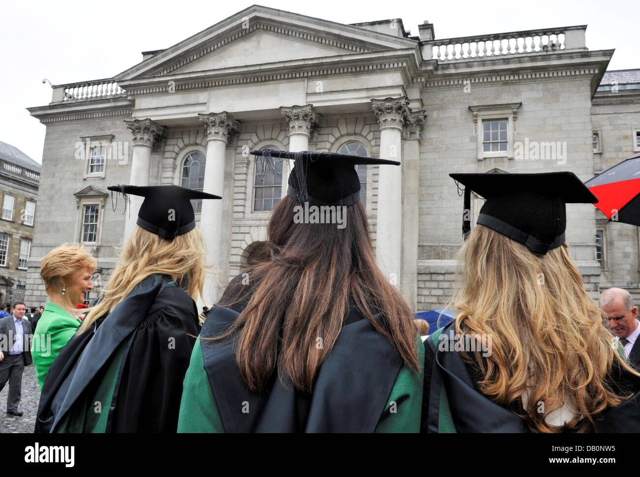 Graduates of Trinity College in Dublin pose for a photgrapher in front of a College building in Dublin, on June27, 2013. Stock Photo