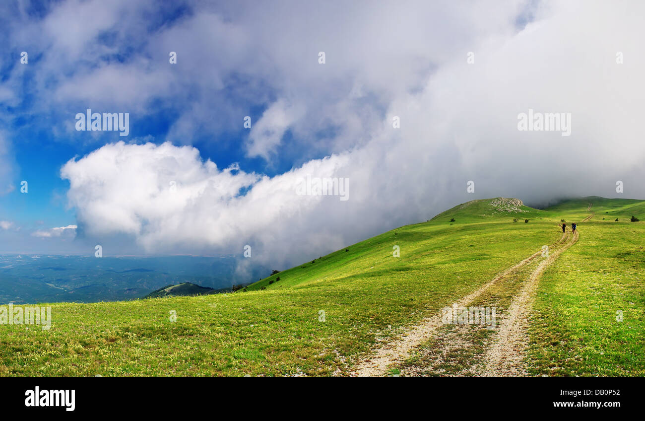 Road on the mountain and cloudy sky. Beautiful summer landscape Stock ...