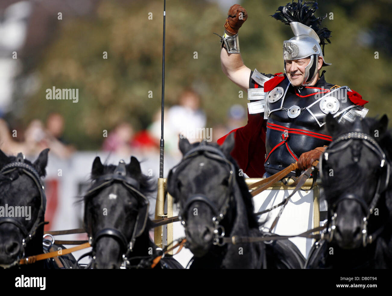 A charioteer on his quadriga greets the spectators during the 'Great Chariot Race of Ben Hur' in Berlin, Germany, 23 September 2007. The race of the quadrigae was the highlight at the event. Photo: Klaus-Dietmar Gabbert Stock Photo