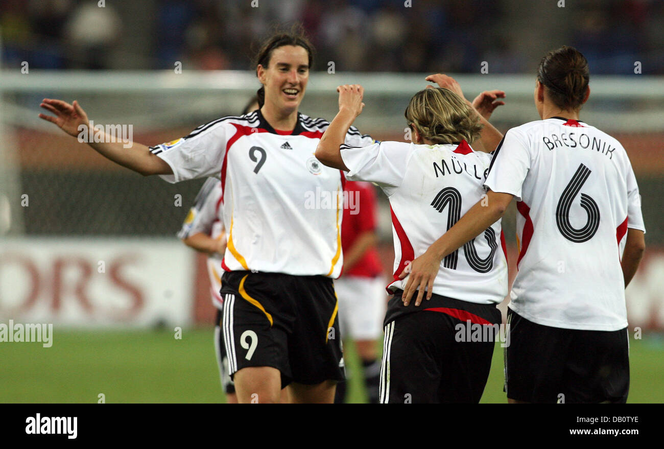 Germany s Birgit Prinz L And Linda Bresonik R Cheer With Goalgetter germany-s-birgit-prinz-l-and-linda-bresonik-r-cheer-with-goalgetter