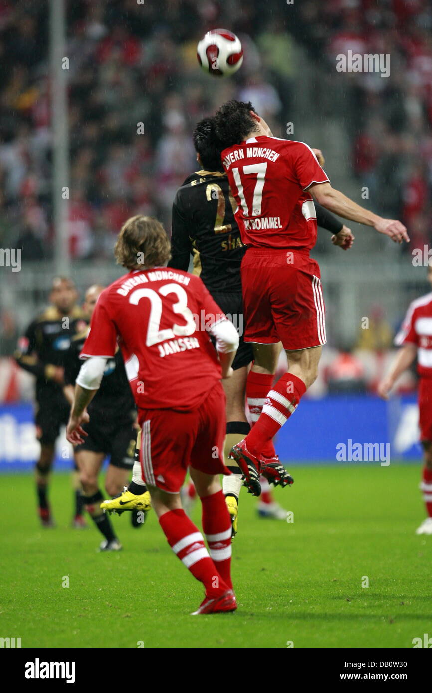 Mark Van Bommel R Of Fc Bayern Munich Fights For The Ball With Jiayi Shao C Of Energie Cottbus During The Seventh Bundesliga Matchday At Allianz Arena In Munich Germany 26 September 2007
