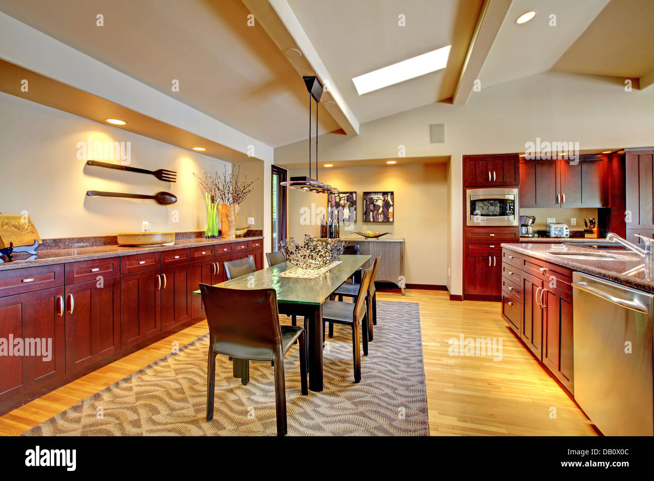 Luxury modern dining room with mahogany kitchen. Stock Photo