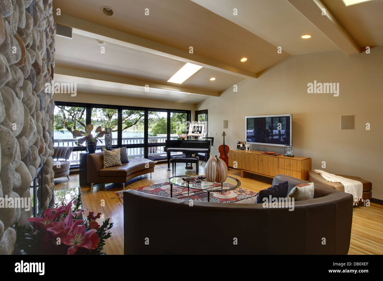 Open modern luxury home interior living room and stone fireplace Stock ...