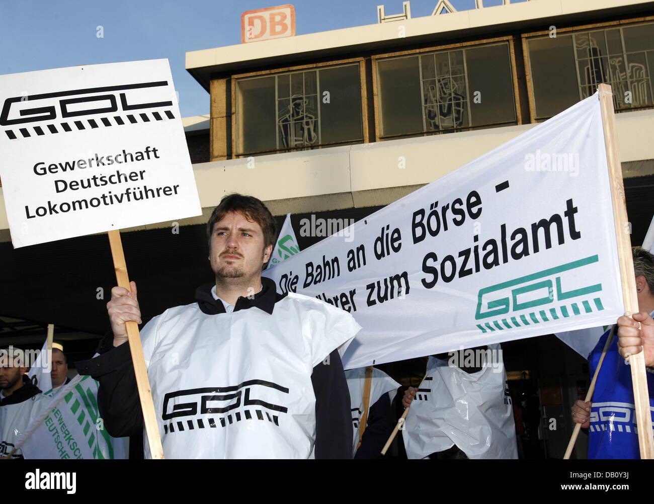 Members of the German trade-union present in train companies (GDL) gather with posters in front of the main train station in Dortmund, Germany, 05 October 2007. Trains run less frequent according to a substitute time table since early this morning due to the engine drivers' strike. A spokesperson of the German railways company 'Deutsche Bahn' (DB) assured customers in Berlin that I Stock Photo