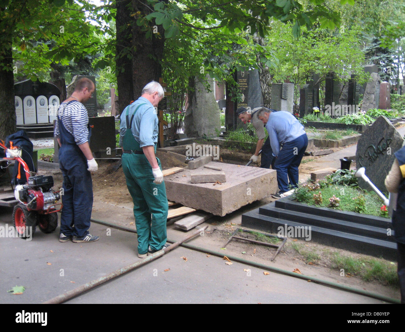 Workers dig a grave at the Novodevichy Cemetery in Moscow, Russia, 30