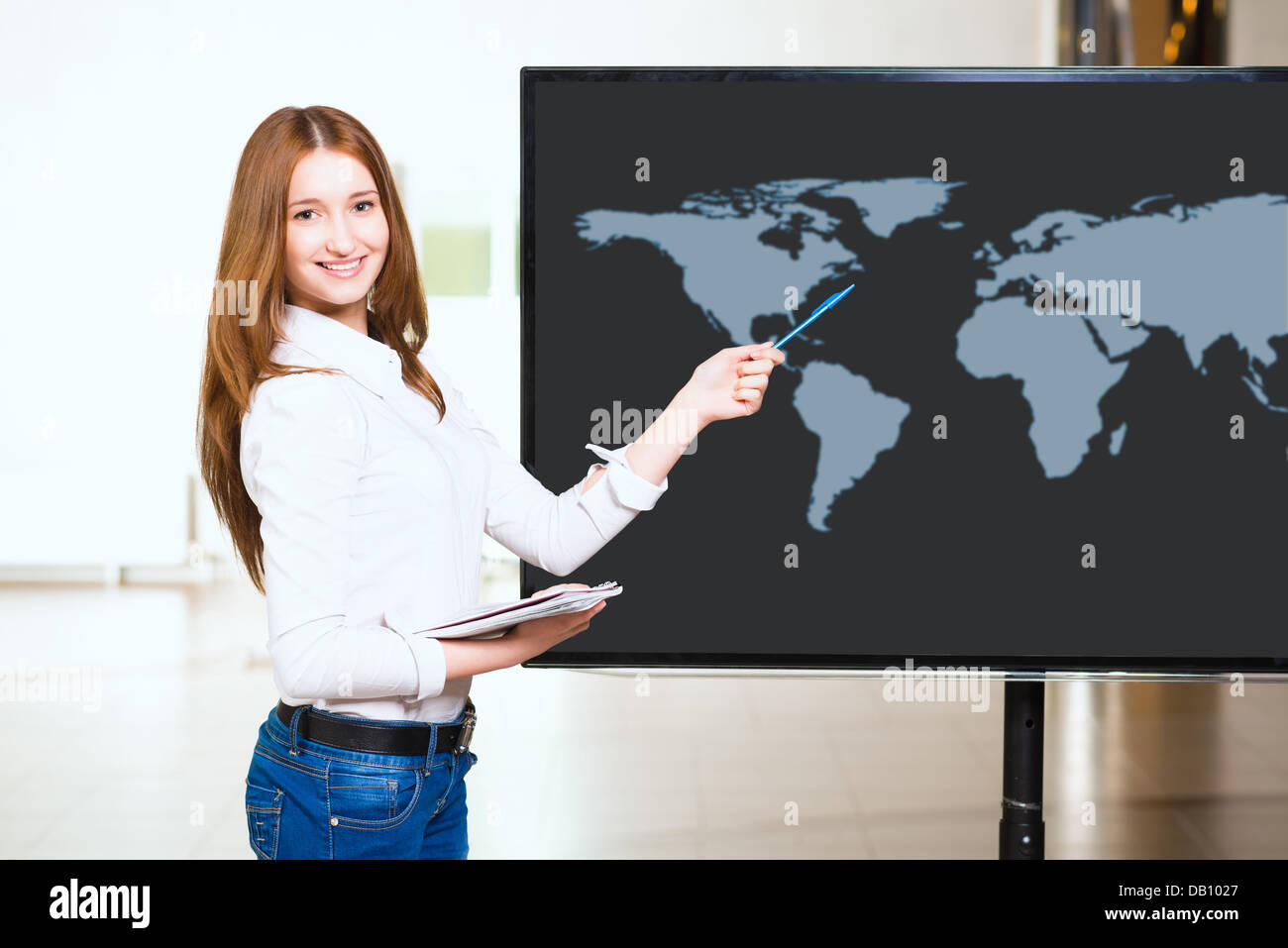 young business woman shows map of world Stock Photo - Alamy
