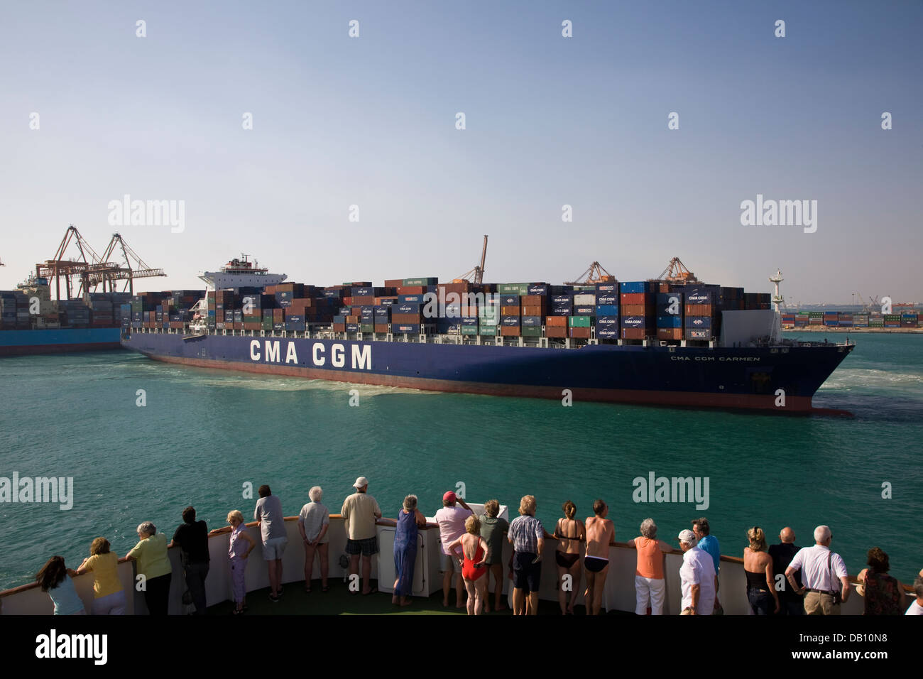 Tourists observe activities in the busy port of Jeddah, Saudi Arabia. Stock Photo