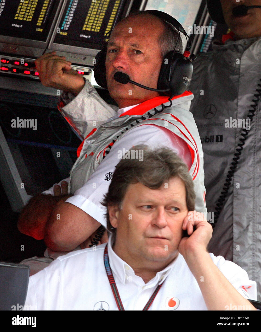 British Ron Dennis (back), team principal of McLaren Mercedes, and German Norbert Haug (front), Mercedes Motorsport Director, during the wet first practice session at the Carlos Pace race circuit in Interlagos near Sao Paulo, Brazil, 19 October 2007. McLaren Mercedes' rookie driver, Briton Lewis Hamilton, could become the first-ever rookie Formula One World Champion when the decisi Stock Photo