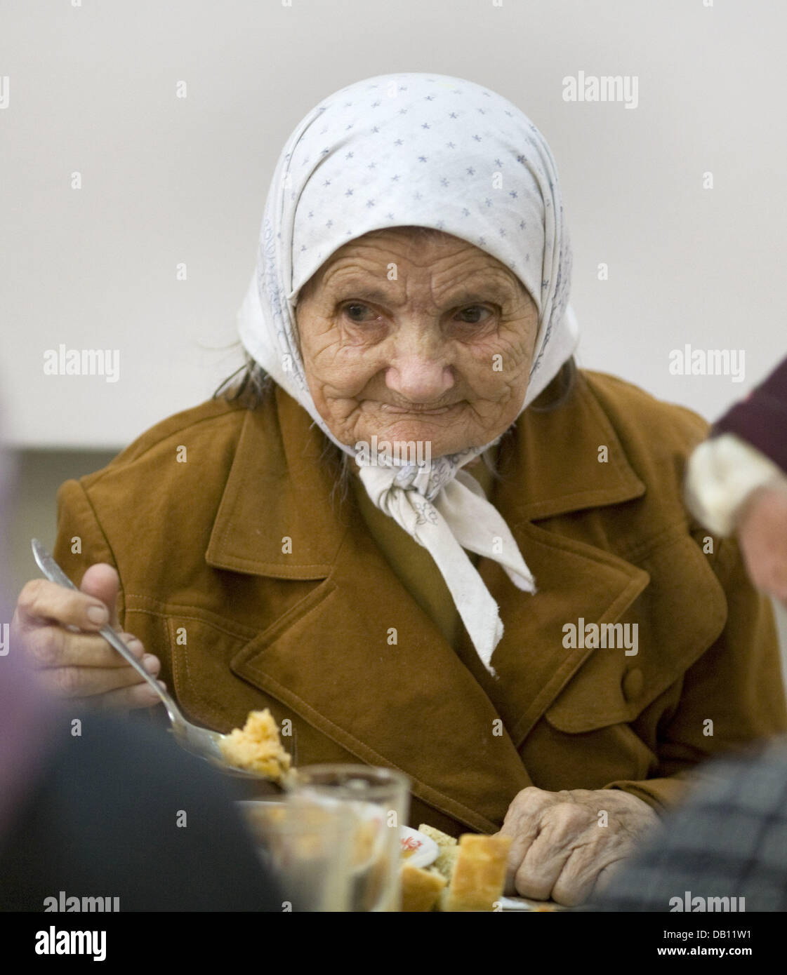 An elderly woman of German origin has lunch at a social centre in ...