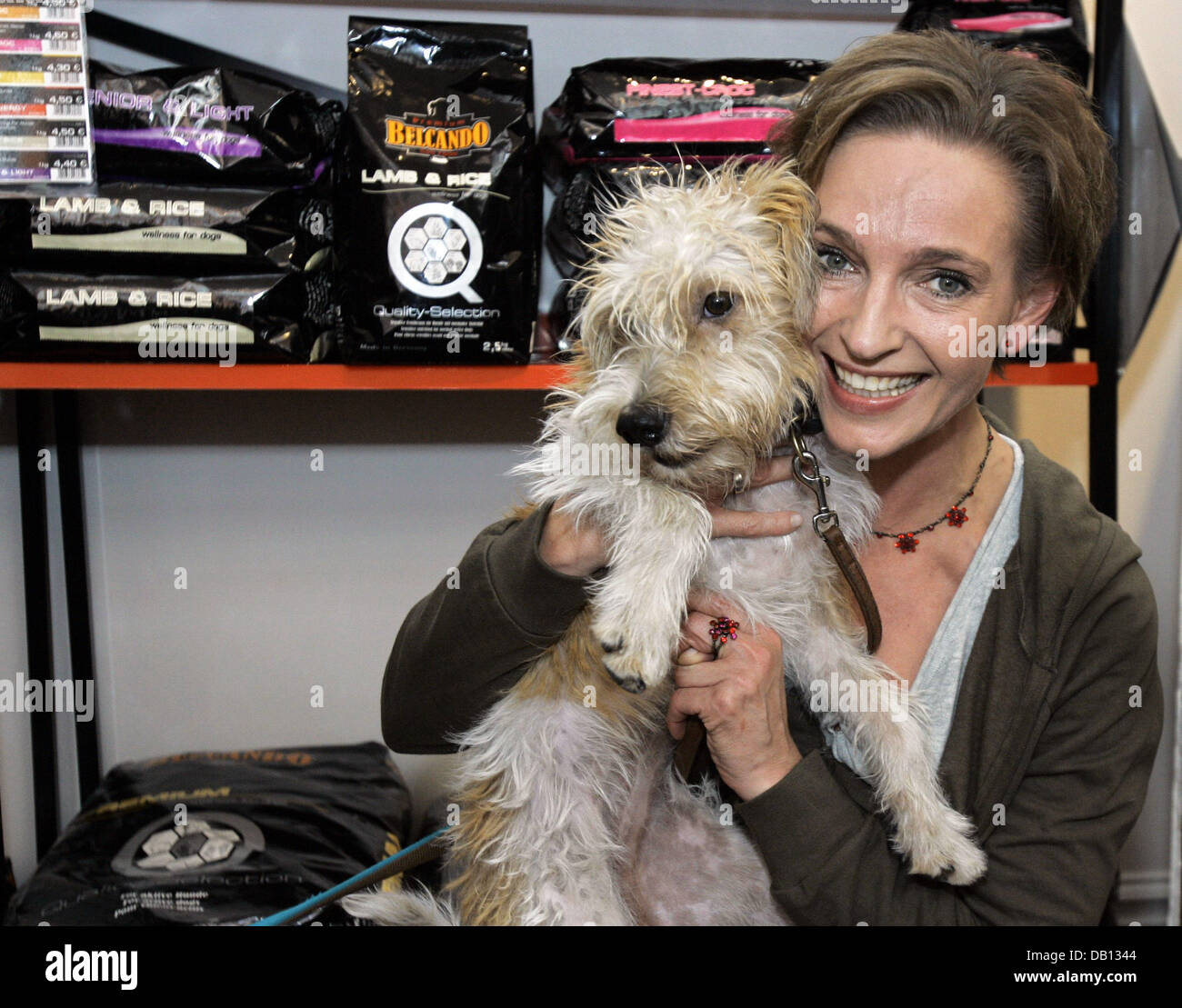 Actress Conny Niedrig poses with a dog at the opening of her dog parlour in Essen, Germany, 28 October 2007. With the opening  of the shop a long entertained youth dream came true for Niedrig, who stars in the SAT1 serial ?Niedrig und Kuhnt?. Photo: Joerg Carstensen Stock Photo