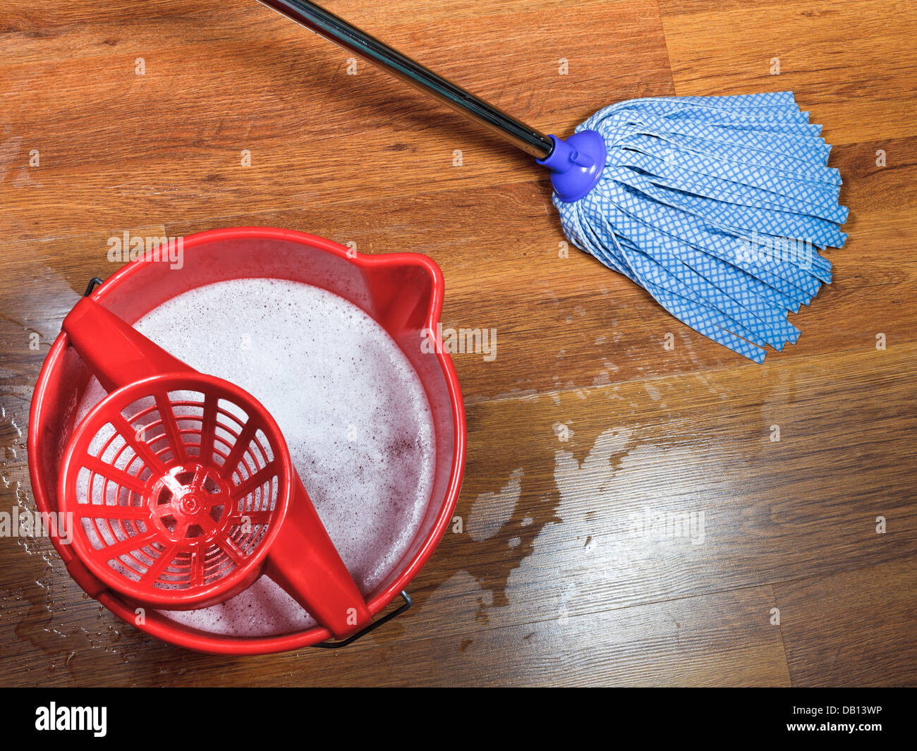 Mopping Of Wooden Floors And Red Bucket With Washing Water Stock