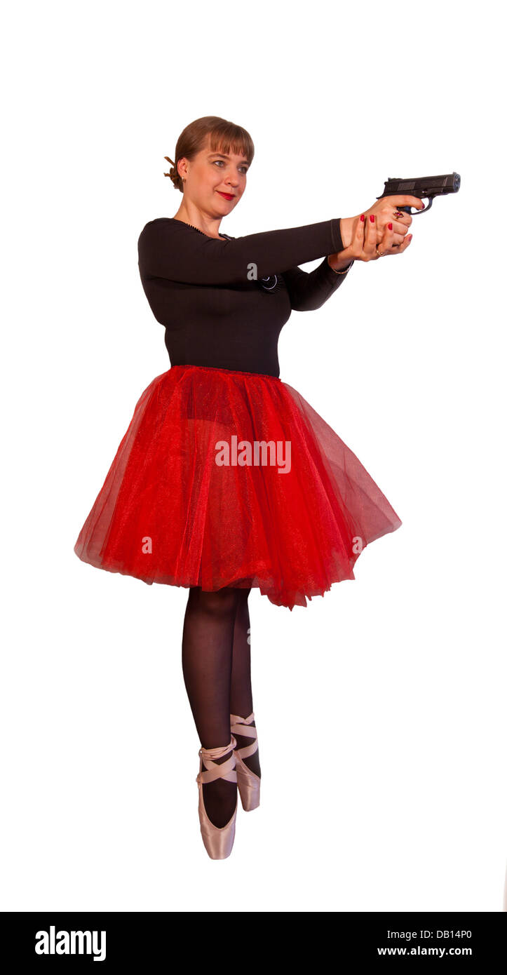 Young attractive woman in black-red ballerina dress holds black gun by two hands on isolated background Stock Photo
