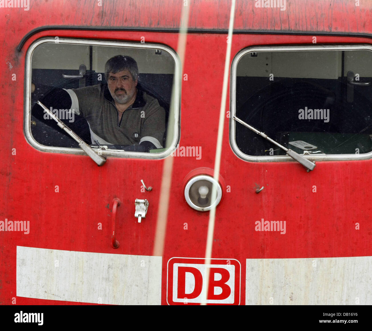 The picture shows an engine driver in a locomotive at freight depot ...