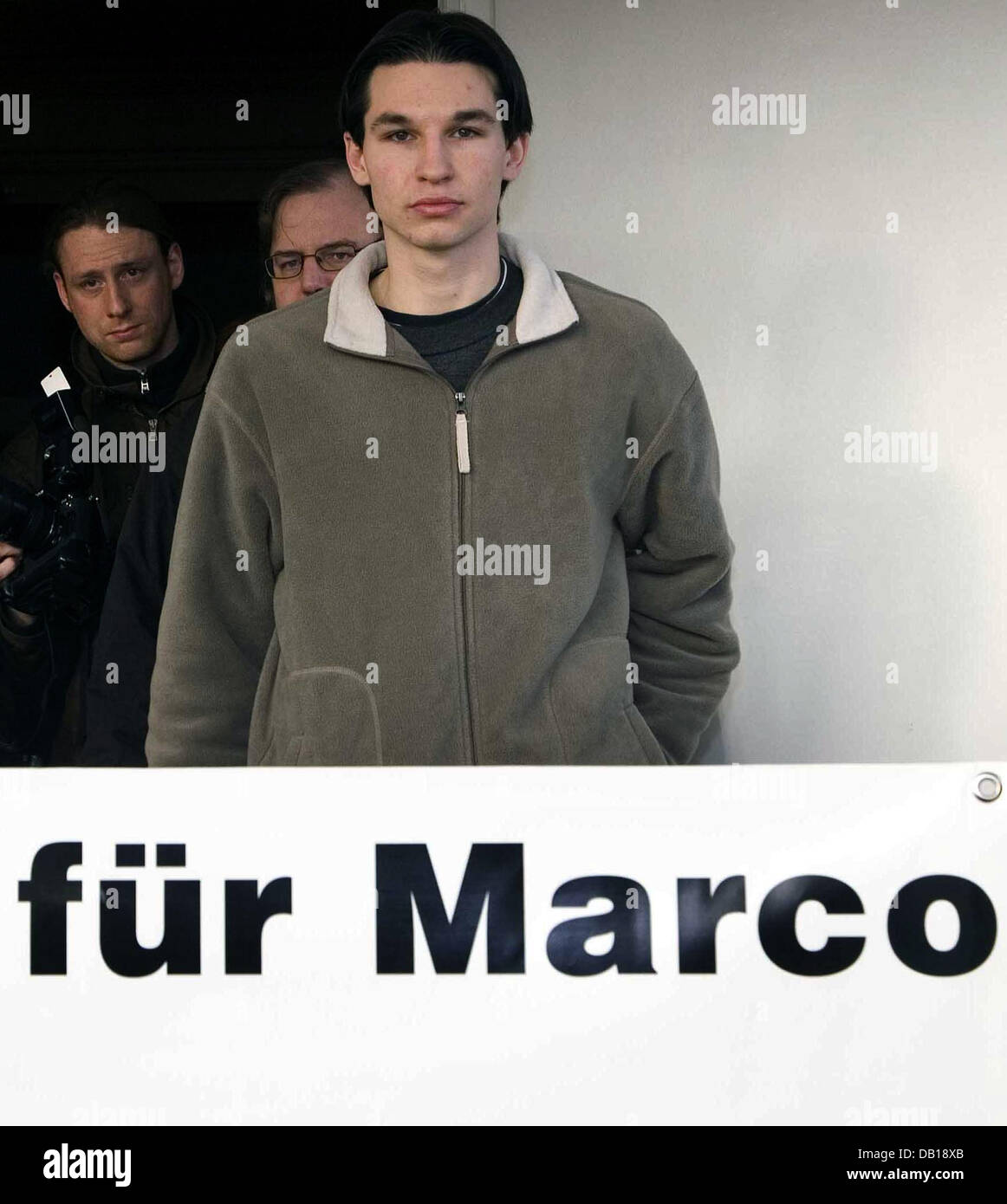 Sascha W. (R), brother of 17-year-old Marco W., poses with a placard after a press conference in Uelzen, Germany, 20 November 2007. Marco W. will remain in Turkish remand until 14 December at the least, only then the proceedings will be continued. Marco's condition is described as stable, but his attourneys fear a skin disease might perilously worsen under the present conditions of Stock Photo