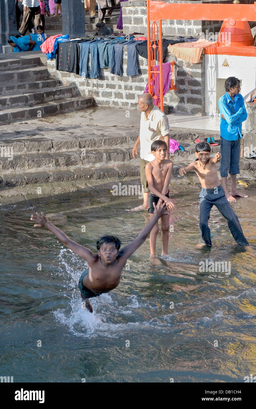 Nashik, Maharashtra, India. 15th May 2008. Young Indian boys swim in the River Godavari in Nashik, Maharashtra. Stock Photo