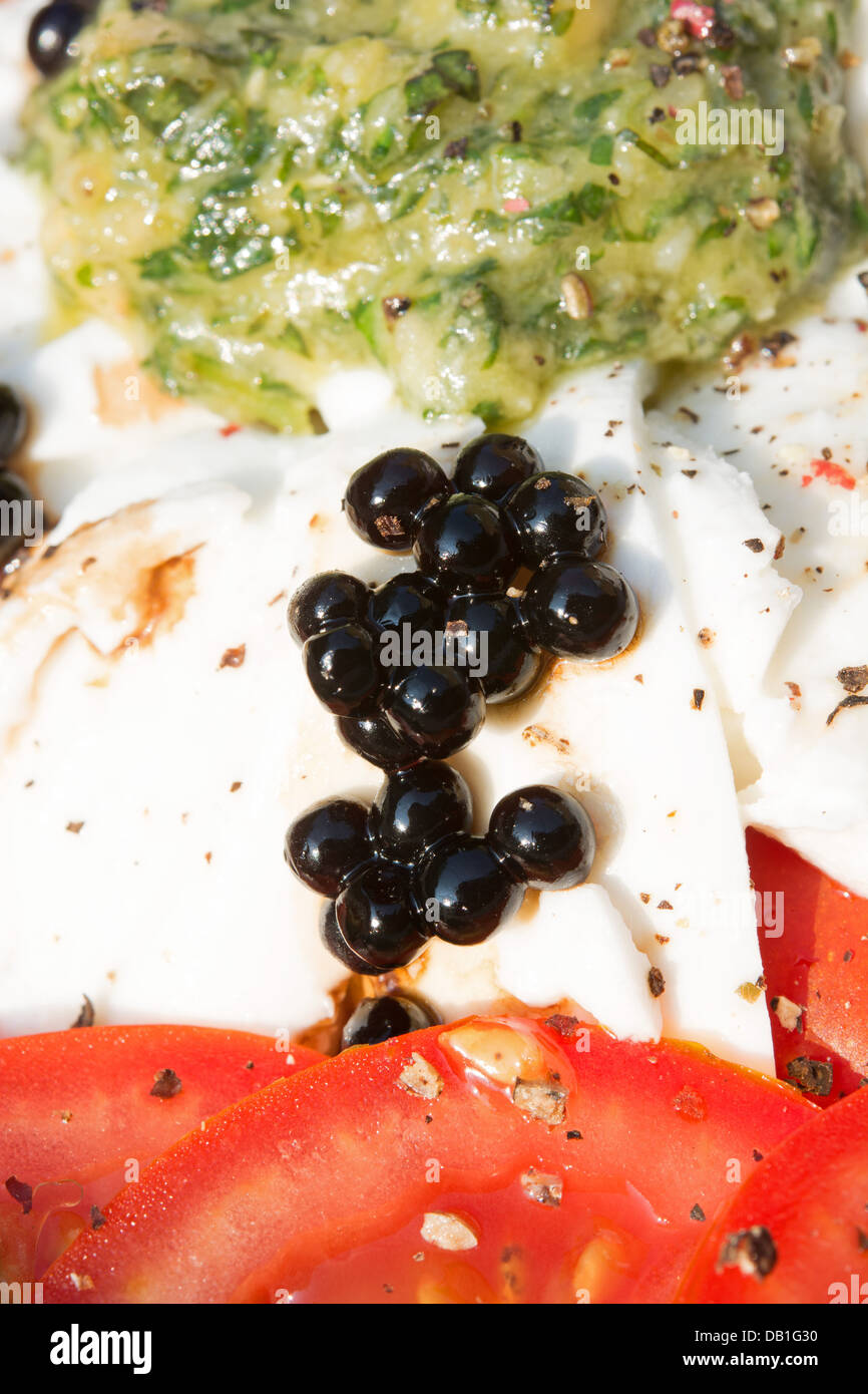 Balsamic vinegar pearls on buffalo Mozzarella with tomatoes and a fresh