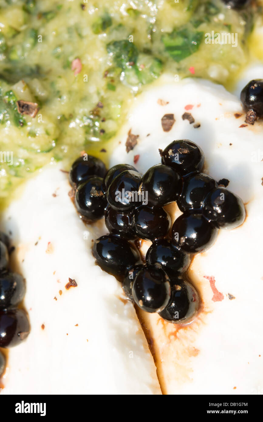 Balsamic vinegar pearls on buffalo Mozzarella, with a fresh pesto