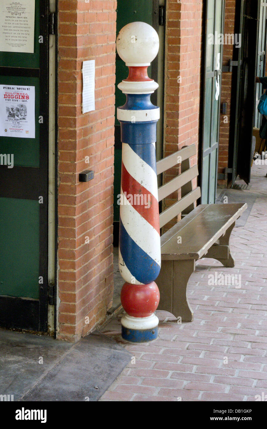 A barber pole outside a califonian shop. A tradition dating back to the middle ages dictates the colours of the pole. Stock Photo