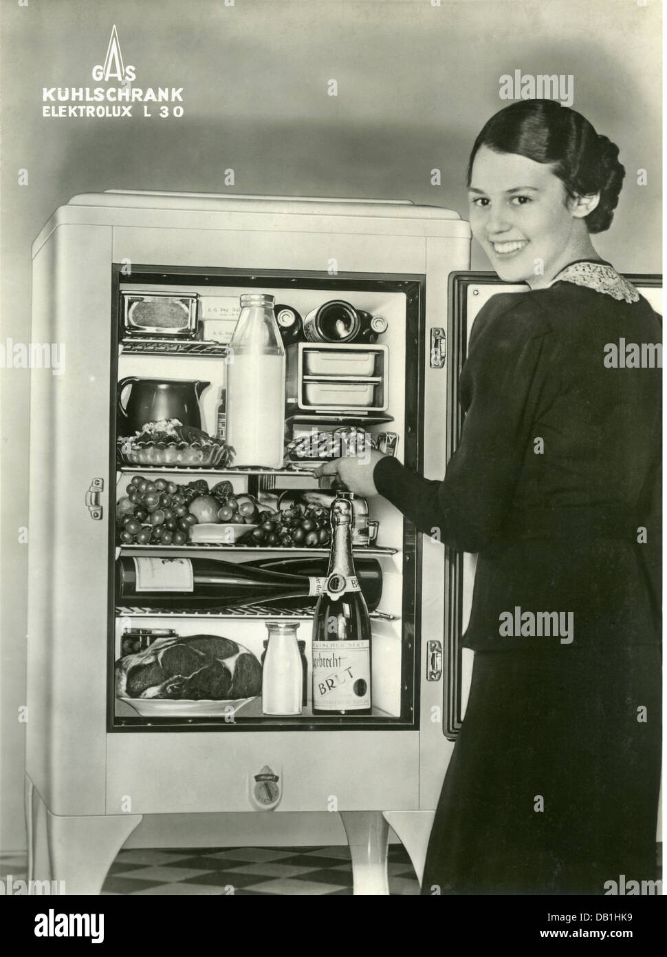 household,refrigerator,advertising for gas powered refrigerator Elektrolux L 30,housewife at open refrigerator,Germany,1937,opened,open,luxury,luxuries,gas,fluid,gases,cooling,cool,store,stores,store up,supply,household,households,kitchen,kitchens,technical progress,technological advance,household appliance,domestic appliance,household utensil,household appliances,domestic appliances,household utensils,advertising,smile,smiles,30s,1930s,kitchen appliance,kitchen device,kitchen utensil,kitchen furniture,freshness,fresh,f,Additional-Rights-Clearences-Not Available Stock Photo