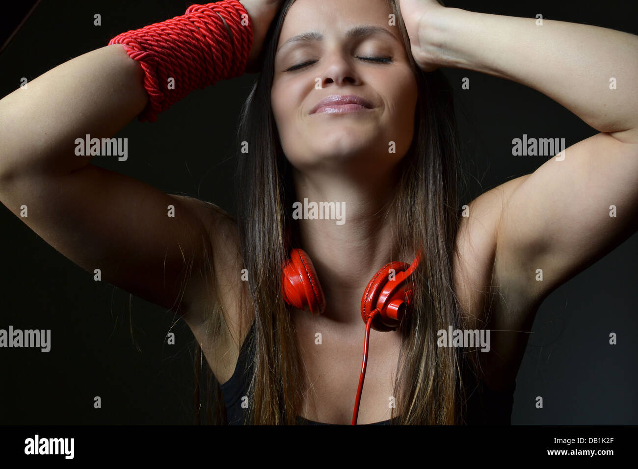 A beautiful young woman with the red headphones Stock Photo