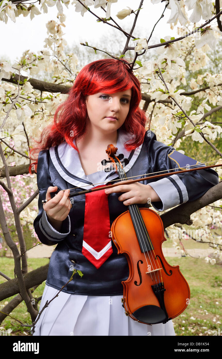 Teenage girl with a violin in the blooming garden Stock Photo - Alamy