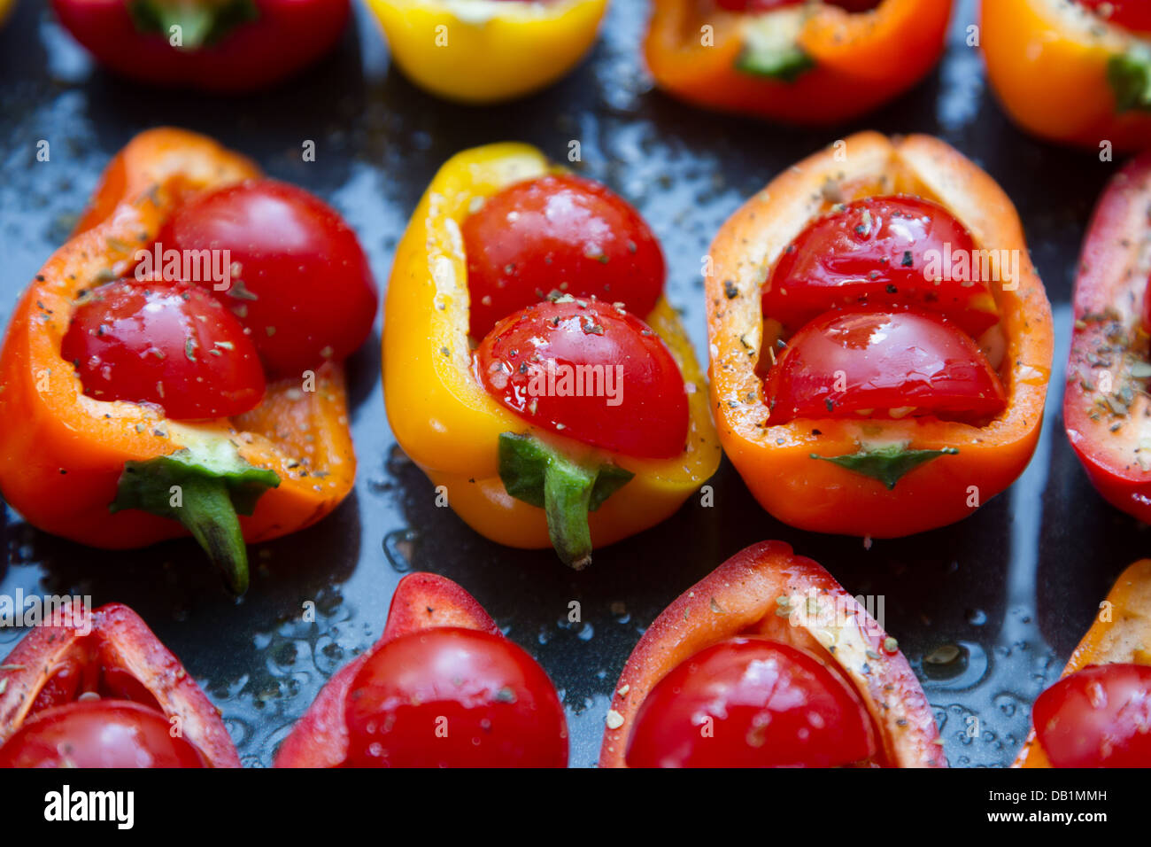 Sweet peppers stuffed with cherry tomatoes Stock Photo