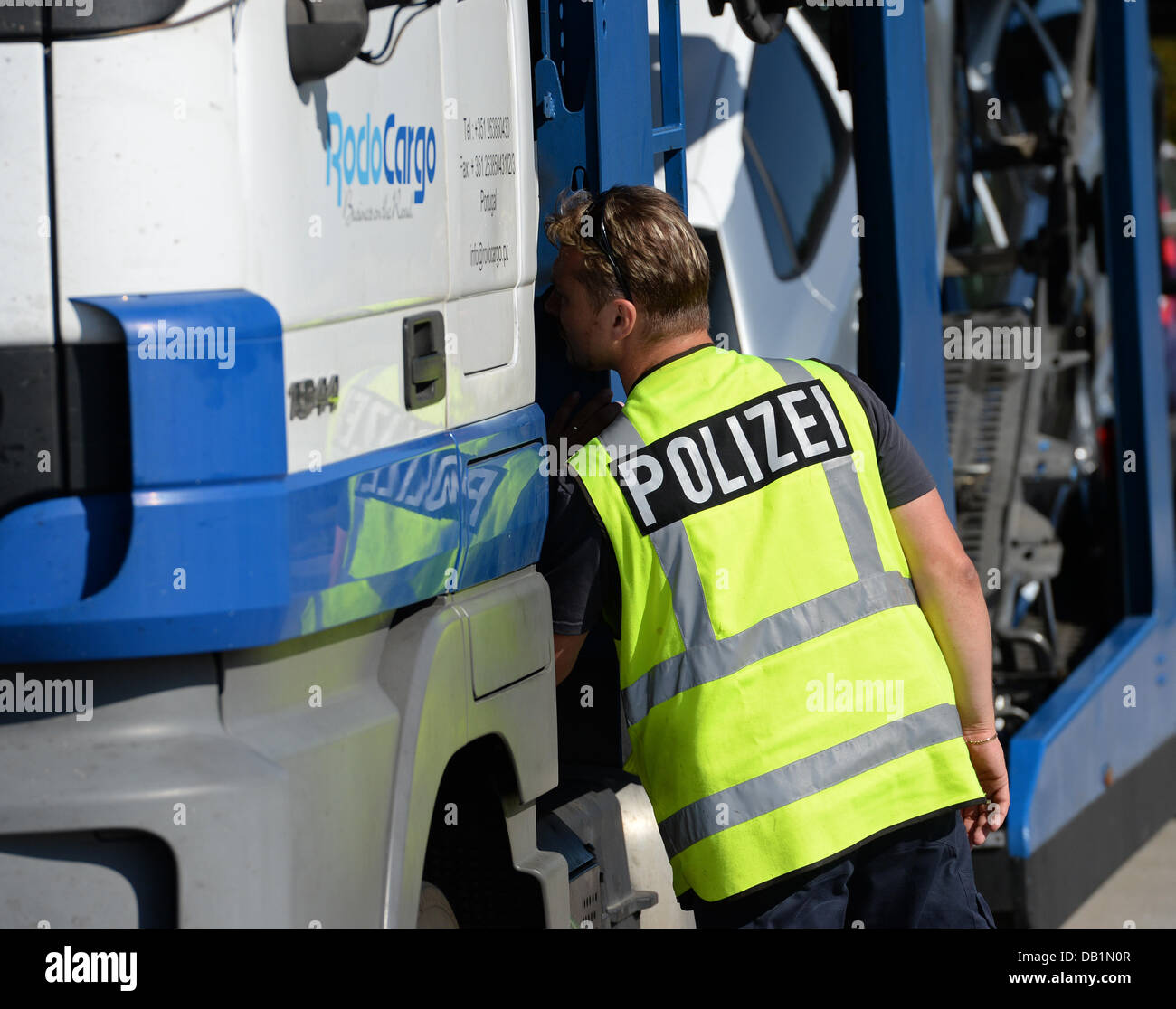 A police officer checks a truck at the A2 motorway near Brandenburg ...