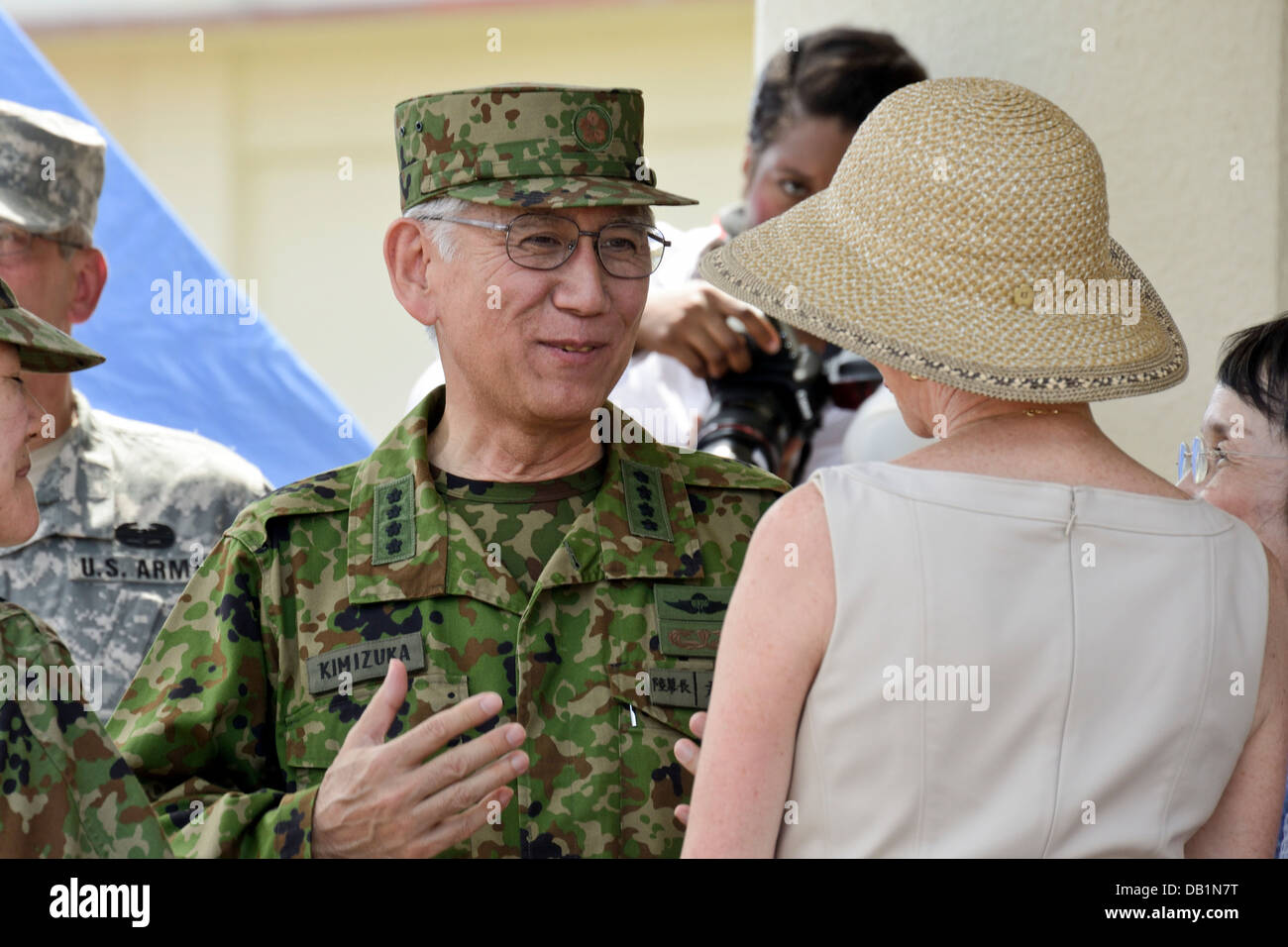 Gen. Eiji Kimizuka speaks with Bonnie Amos July 19 at the Camp Foster parade deck following the III Marine Expeditionary Force c Stock Photo