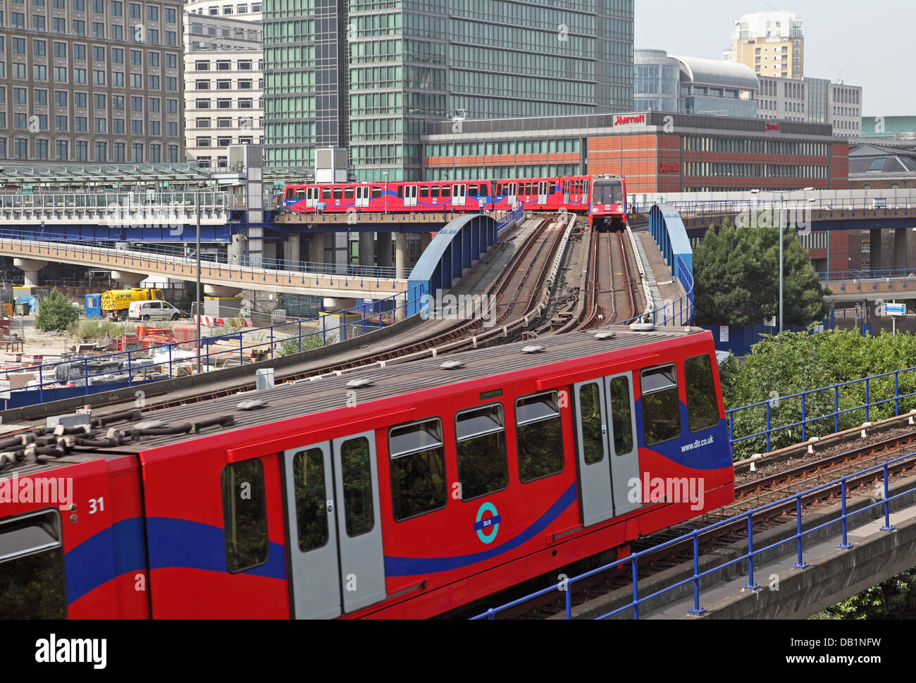 London Docklands Light Railway trains pass near West India Quay station Stock Photo