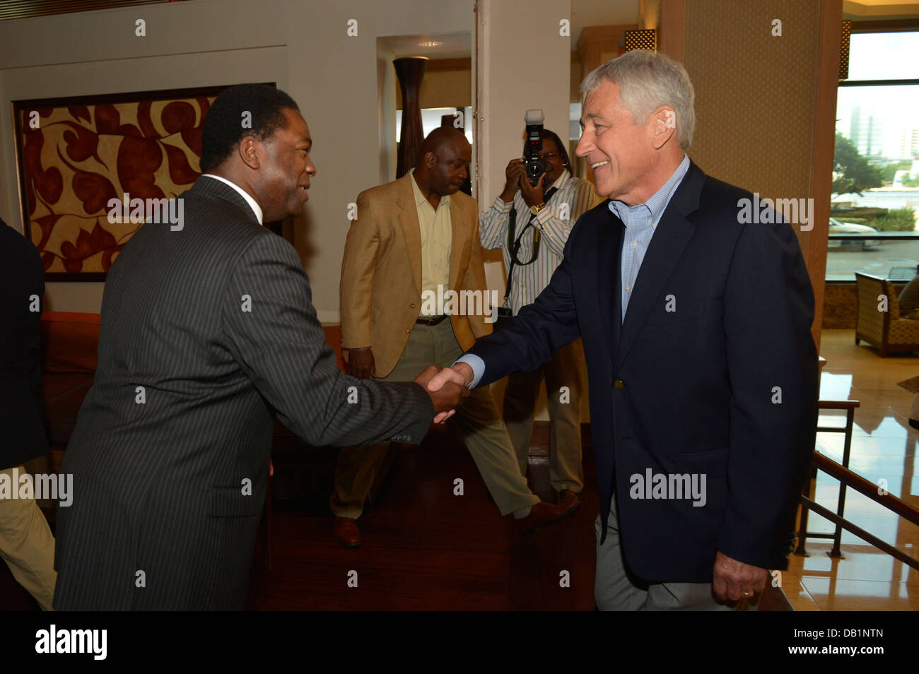 Secretary of Defense Chuck Hagel, right, shakes hands with Jacksonville Mayor Alvin Brown July 16, 2013, in Jacksonville, Fla. The two met before Hagel?s scheduled visit to Naval Air Station Jacksonville as part of a three-day trip to visit several instal Stock Photo