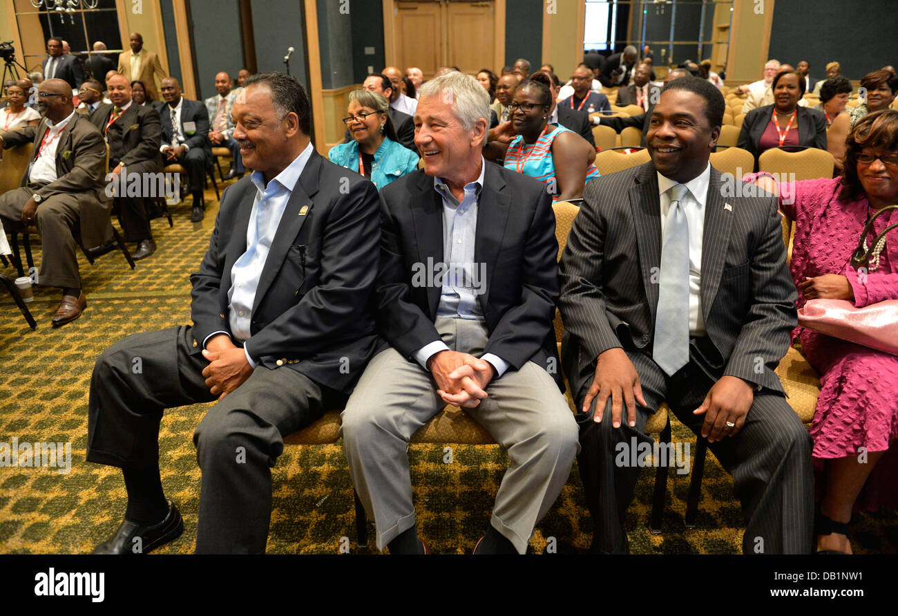Secretary of Defense Chuck Hagel, center, sits with civil rights activist the Rev. Jesse Jackson, left, and Jacksonville Mayor Alvin Brown during the Conference of Minority Transportation Officials July 16, 2013, in Jacksonville, Fla. Hagel was en route t Stock Photo