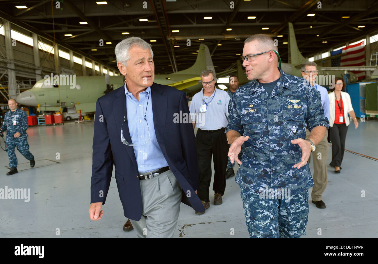 U.S. Navy Capt. Robert Caldwell, right, the commanding officer of Fleet Readiness Center Southeast, escorts Secretary of Defense Chuck Hagel on a tour of the facility July 16, 2013, at Naval Air Station Jacksonville, Fla. Hagel was on a three-day trip to Stock Photo