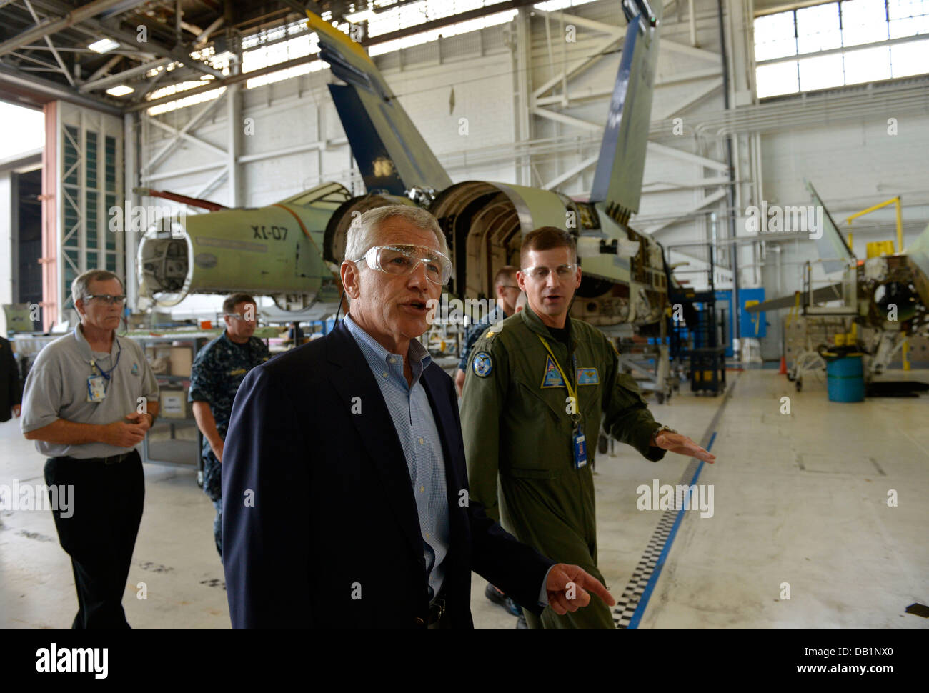 Secretary of Defense Chuck Hagel, left foreground, tours Fleet Readiness Center Southeast July 16, 2013, at Naval Air Station Jacksonville, Fla. Hagel was on a three-day trip to visit several installations on the U.S. East Coast. Stock Photo