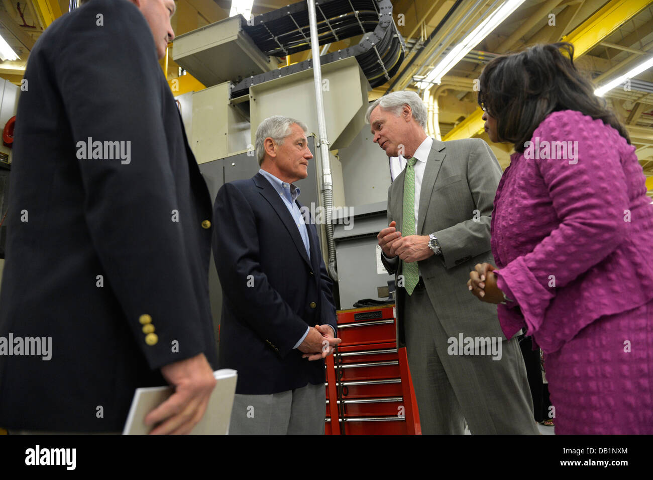 Secretary of Defense Chuck Hagel, center left, speaks with U.S. Reps. Ander Crenshaw, center right, Corrine Brown, right, and Ted Yoho after addressing civilian employees of Fleet Readiness Center Southeast July 16, 2013, at Naval Air Station Jacksonville Stock Photo
