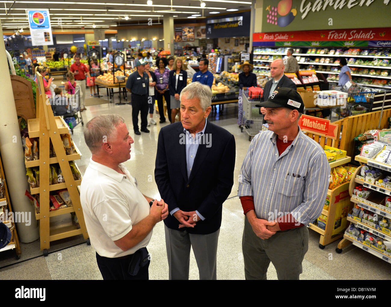 Secretary of Defense Chuck Hagel, center, tours the commissary at Naval Air Station Jacksonville, Fla., July 16, 2013, with store director Larry Bentley, left, and meat department manager John Crayon. Hagel was on a three-day trip to visit several install Stock Photo