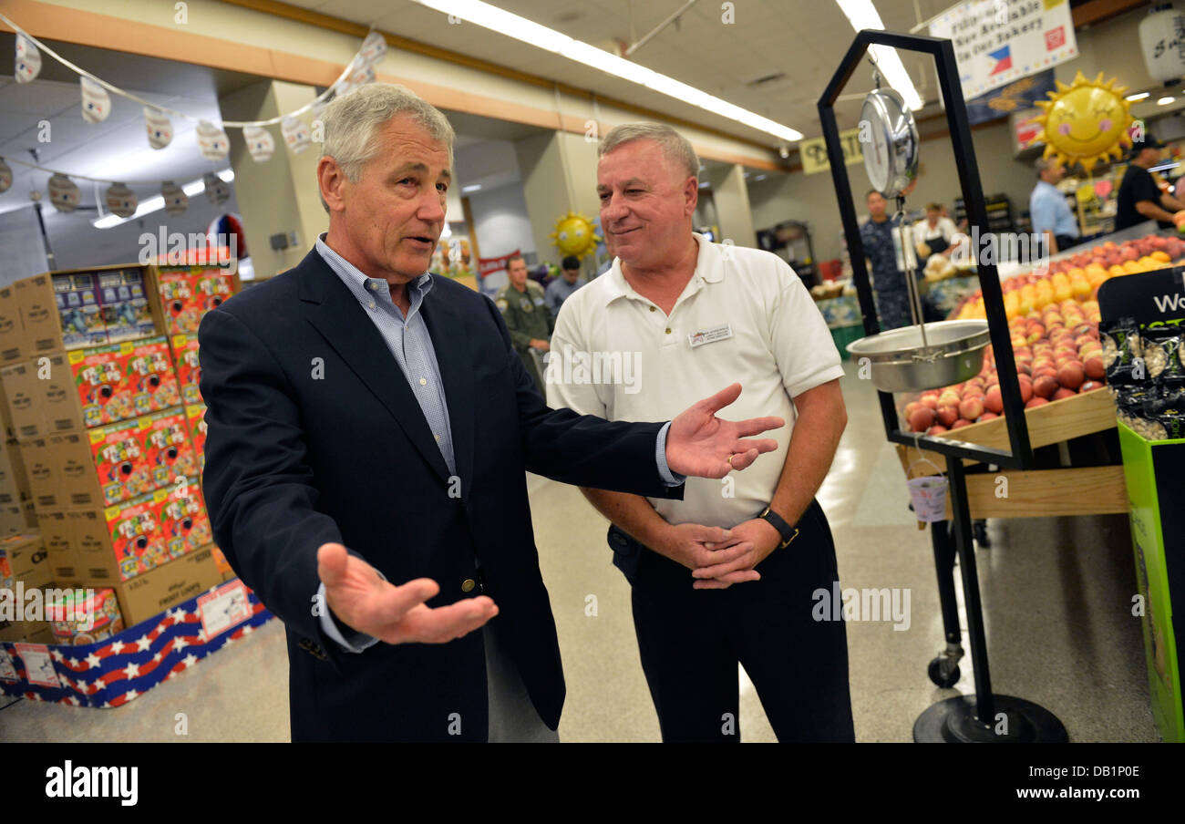 Secretary of Defense Chuck Hagel, left, tours the commissary at Naval Air Station Jacksonville, Fla., with store director Larry Stock Photo
