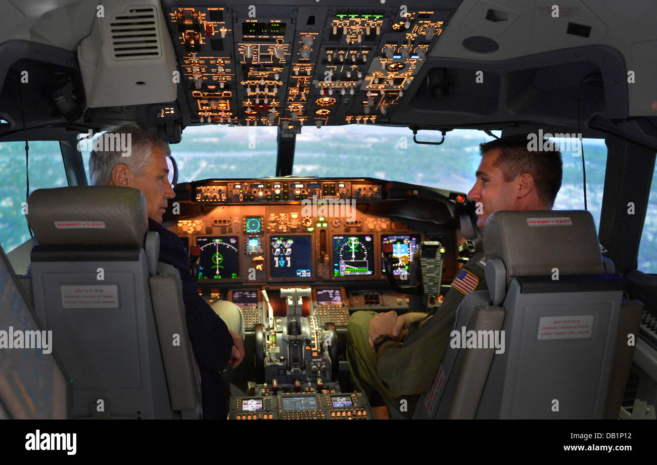 Secretary of Defense Chuck Hagel, left, sits in a U.S. Navy P-8 Poseidon aircraft simulator while visiting the Patrol Squadron (VP) 30 training facility July 16, 2013, at Naval Air Station Jacksonville, Fla. Hagel was on a three-day trip to visit several Stock Photo