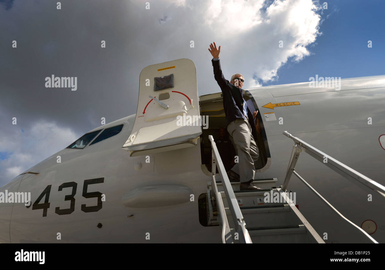 Secretary of Defense Chuck Hagel waves to onlookers as he boards a U.S. Navy P-8 Poseidon aircraft to depart Naval Air Station Jacksonville, Fla., July 16, 2013. Hagel was on a three-day trip to visit several installations on the U.S. East Coast. Stock Photo