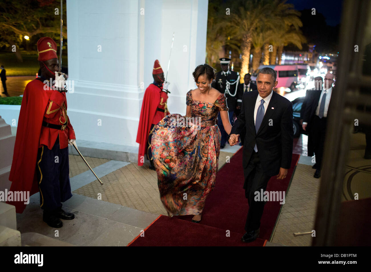 US President Barack Obama and First Lady Michelle Obama arrive for an official dinner at the Presidential Palace June 27, 2013 in Dakar, Senegal. Stock Photo
