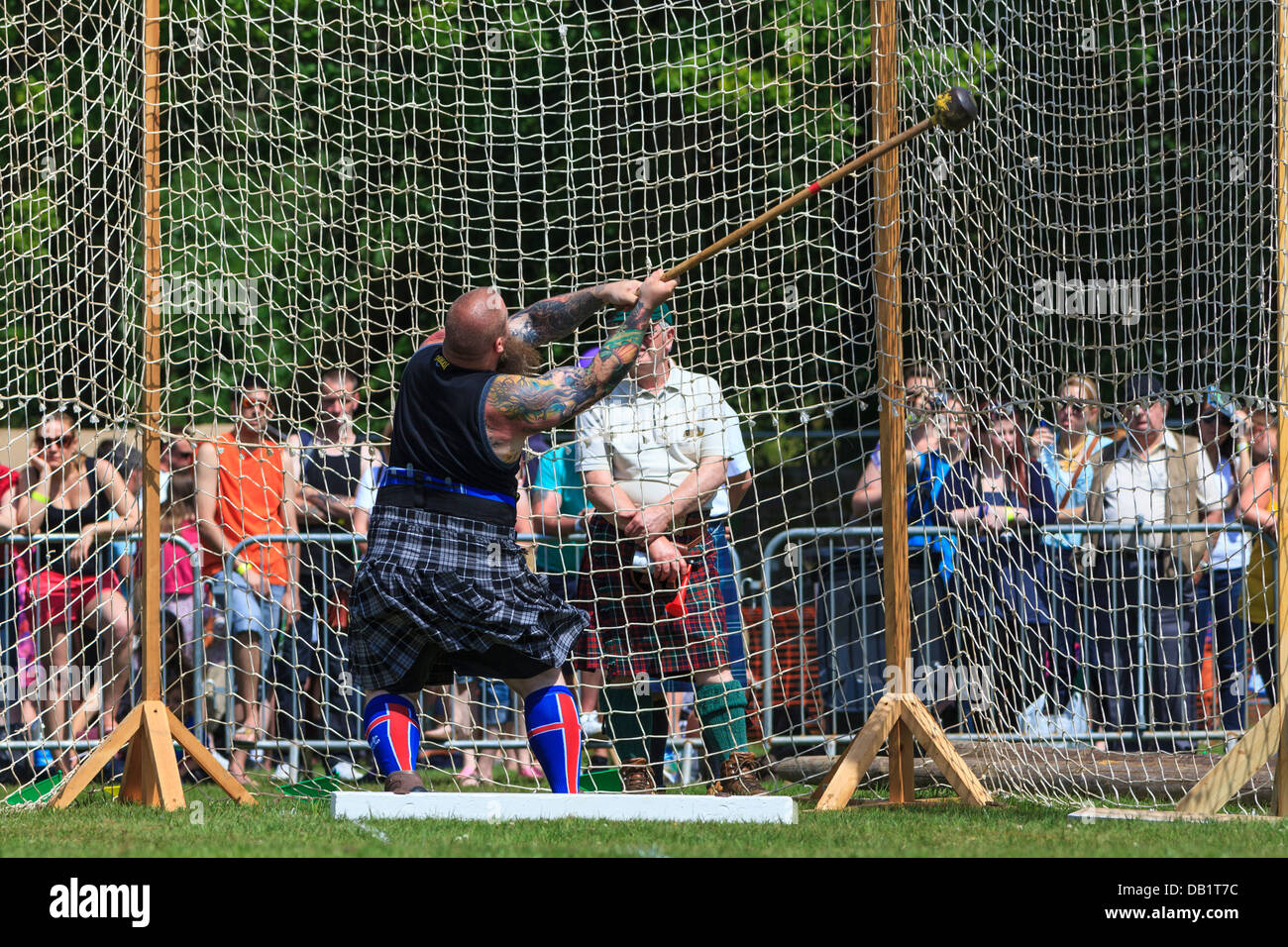 Competitor at Scottish highland games throwing the 22 pound hammer, a