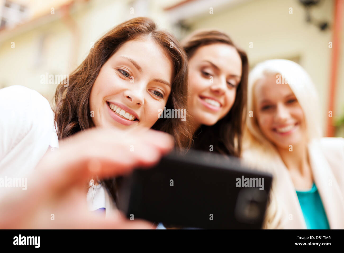 beautiful girls taking picture in cafe in city Stock Photo - Alamy